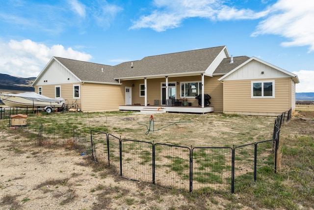 back of property featuring a wooden deck