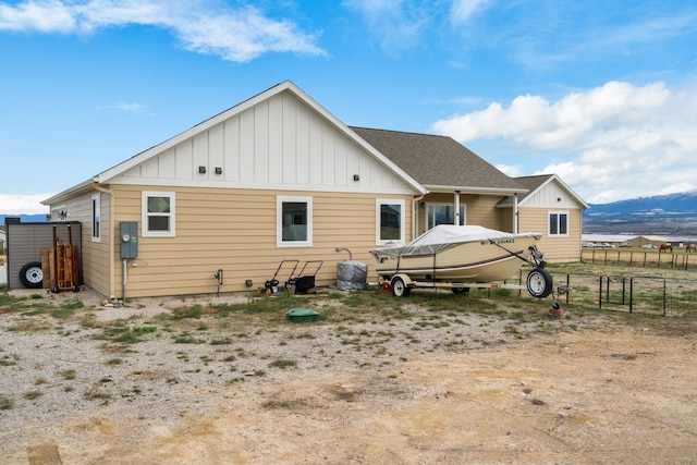 rear view of house featuring a mountain view