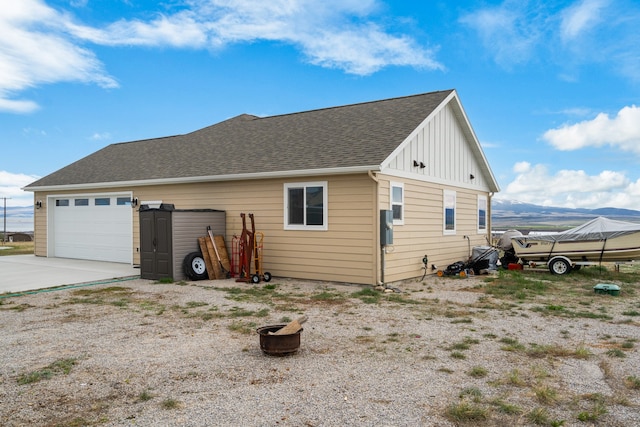 view of property exterior featuring a mountain view and a garage