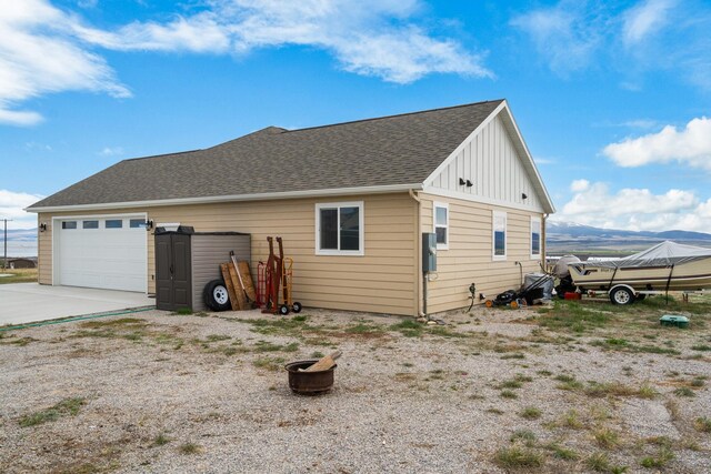 view of property exterior featuring a mountain view and a garage