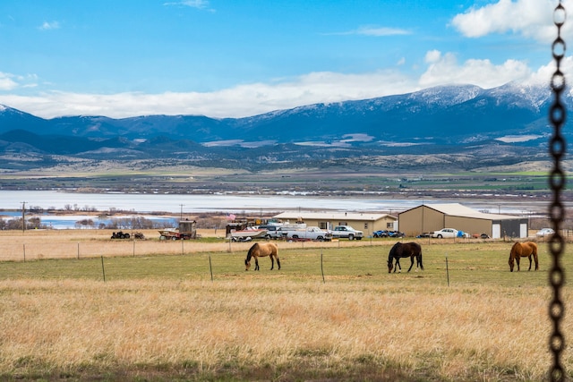 view of mountain feature featuring a water view and a rural view