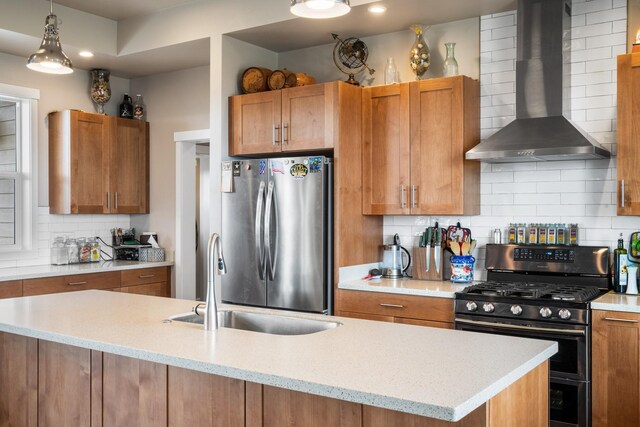 kitchen with wall chimney exhaust hood, stainless steel appliances, and tasteful backsplash