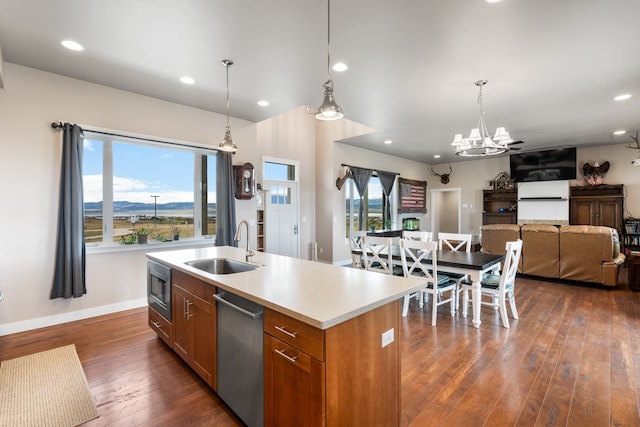 kitchen with a healthy amount of sunlight, a center island with sink, dark hardwood / wood-style flooring, and sink