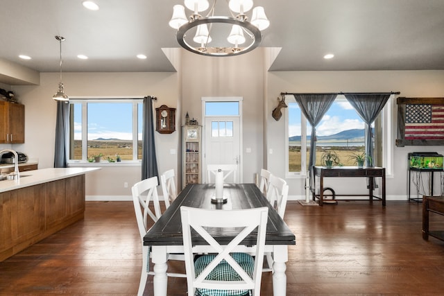 dining space with dark hardwood / wood-style floors, a chandelier, a mountain view, and sink