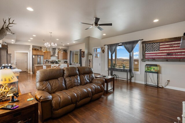 living room featuring ceiling fan with notable chandelier and dark hardwood / wood-style floors