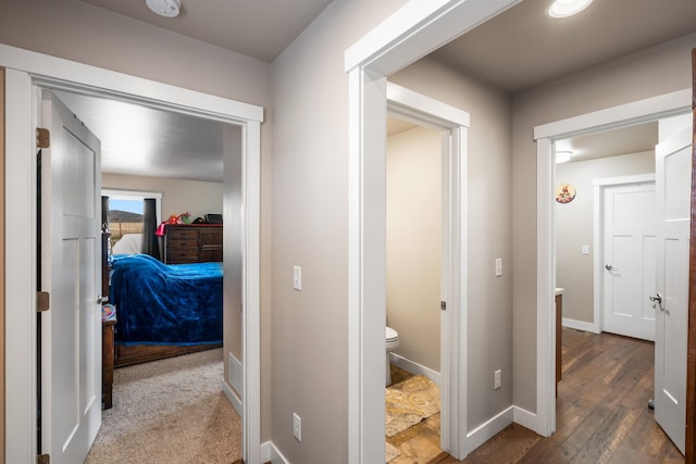 corridor with wood-type flooring