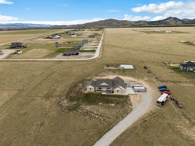 birds eye view of property with a mountain view and a rural view