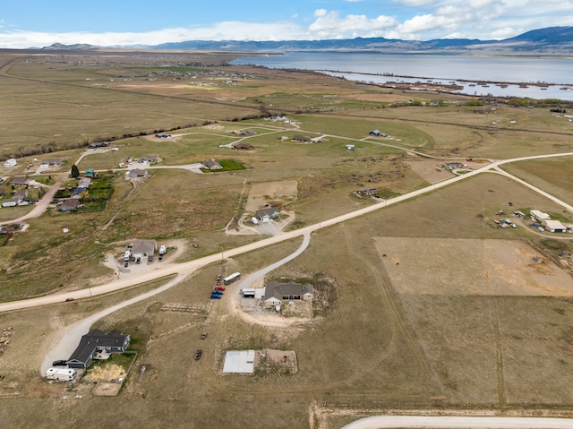 birds eye view of property with a water and mountain view and a rural view