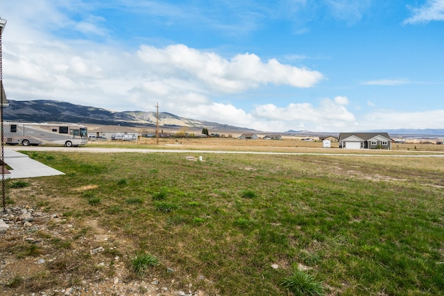 view of yard featuring a mountain view and a rural view