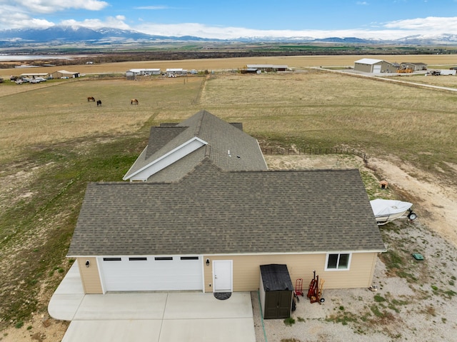 birds eye view of property featuring a mountain view and a rural view