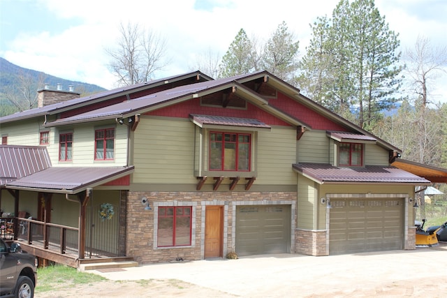 view of front facade with a garage and a mountain view