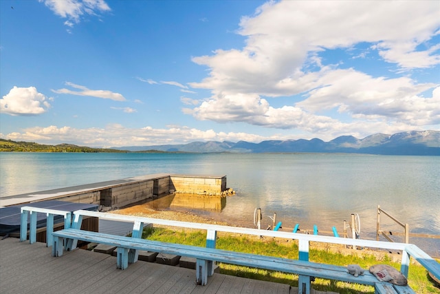 view of dock with a water and mountain view