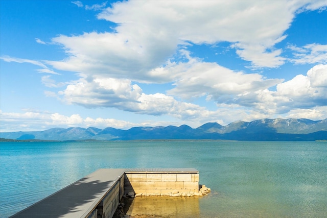 view of dock featuring a water and mountain view