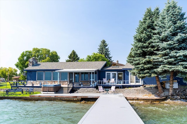 view of dock with a deck with water view and a patio