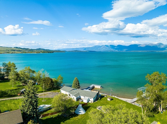 birds eye view of property with a water and mountain view