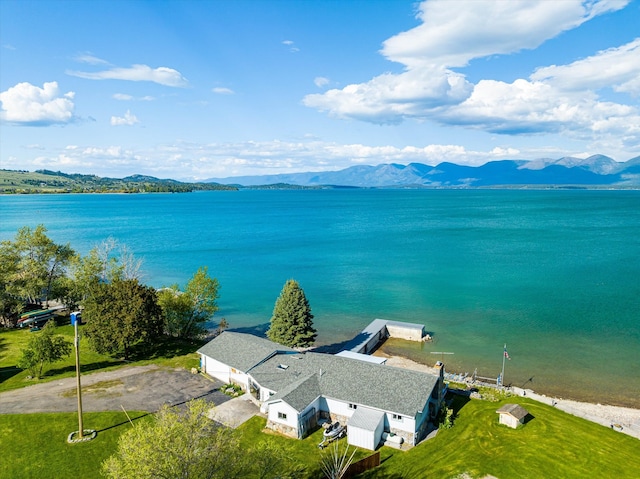 birds eye view of property with a water and mountain view