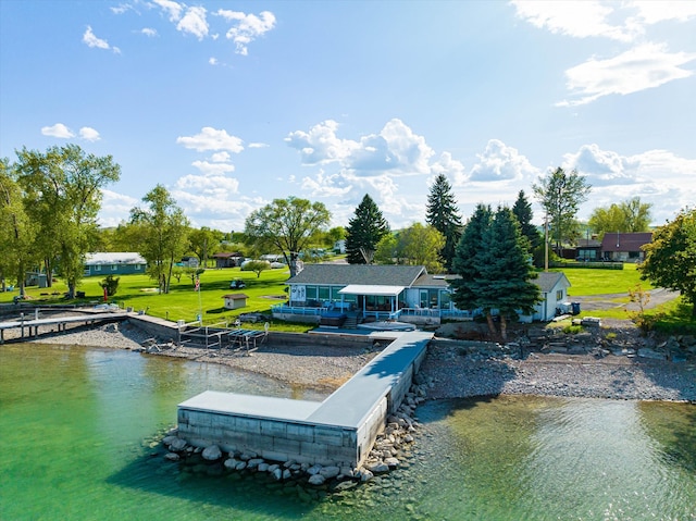 view of dock featuring a water view and a yard