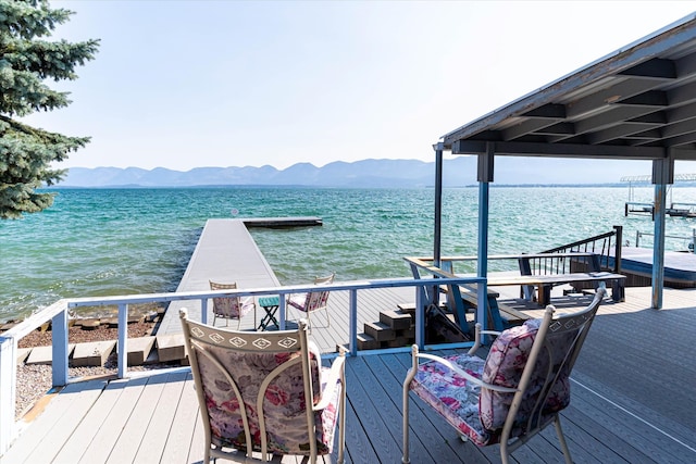 view of dock with a water and mountain view