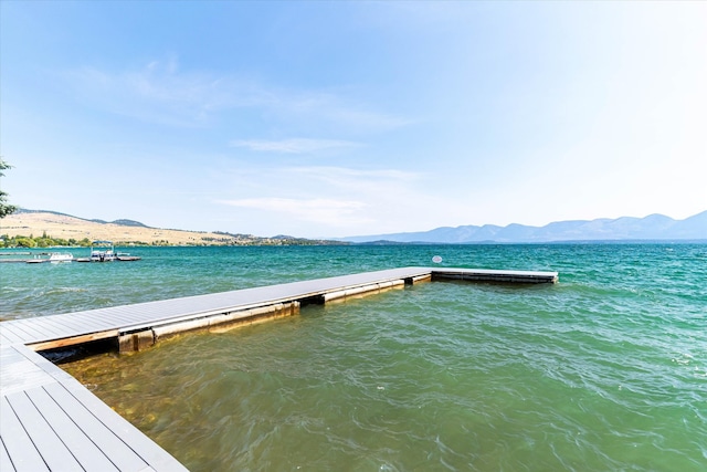 dock area with a water and mountain view