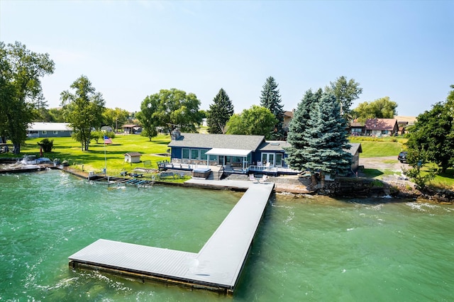 dock area with a water view and a lawn