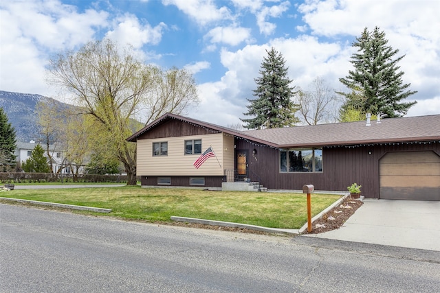 ranch-style house featuring a garage and a front yard