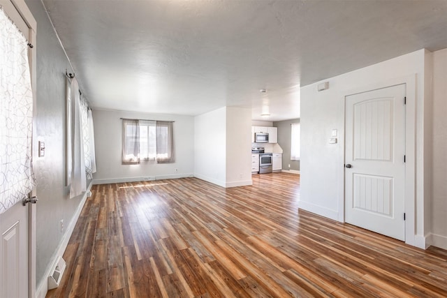 unfurnished living room with hardwood / wood-style flooring