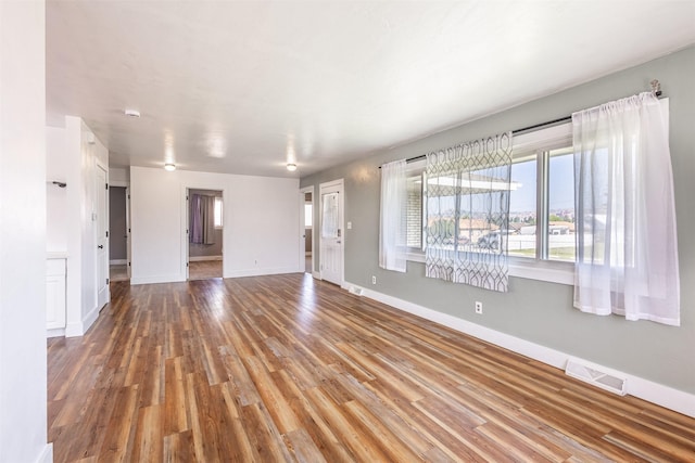 unfurnished living room featuring wood-type flooring