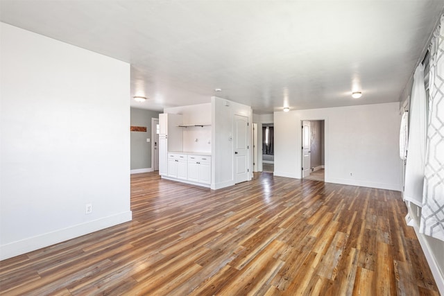 unfurnished living room featuring dark hardwood / wood-style floors