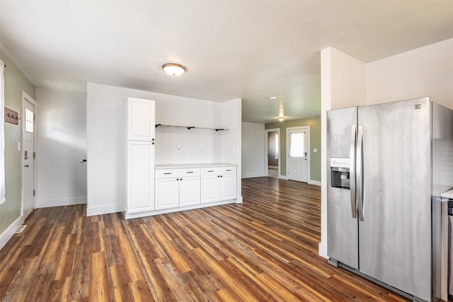 kitchen featuring white cabinetry, dark hardwood / wood-style floors, and stainless steel fridge