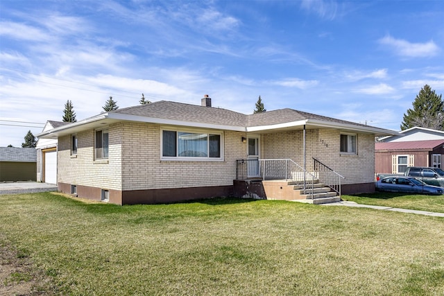 view of front of property with a garage and a front lawn