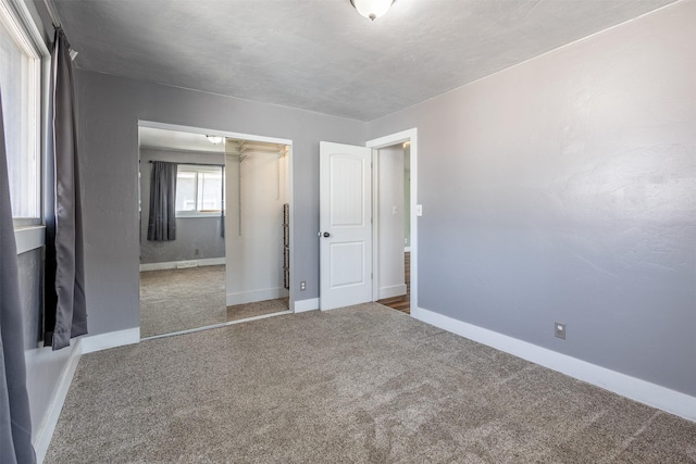 unfurnished bedroom with carpet flooring and a closet