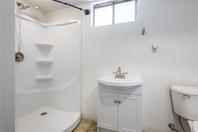 bathroom featuring vanity, toilet, and walk in shower