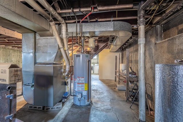 utilities featuring washer and dryer, heating unit, and water heater