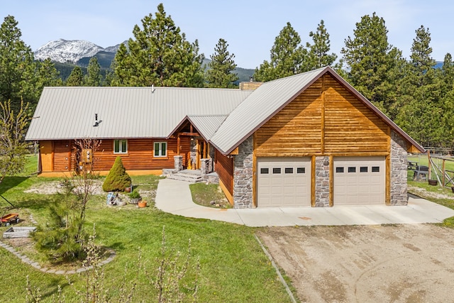 log home with a mountain view and a front lawn