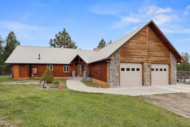 cabin with a garage and a front lawn