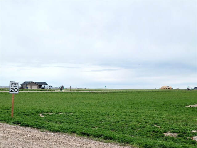 exterior space featuring a lawn and a rural view