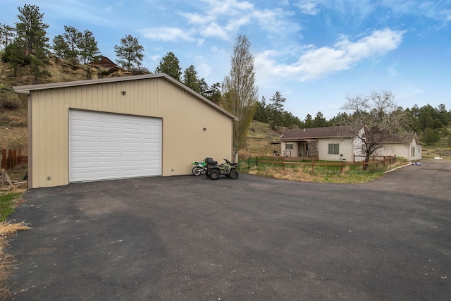 view of front of home featuring a detached garage and an outdoor structure