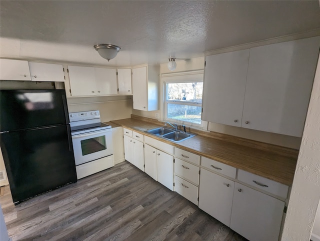 kitchen featuring sink, black fridge, electric stove, white cabinetry, and hardwood / wood-style floors