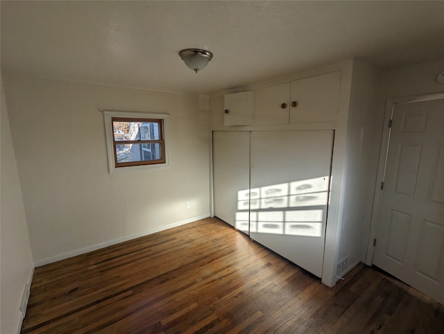 empty room featuring dark hardwood / wood-style flooring