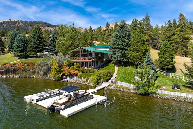 view of dock featuring a yard and a water view