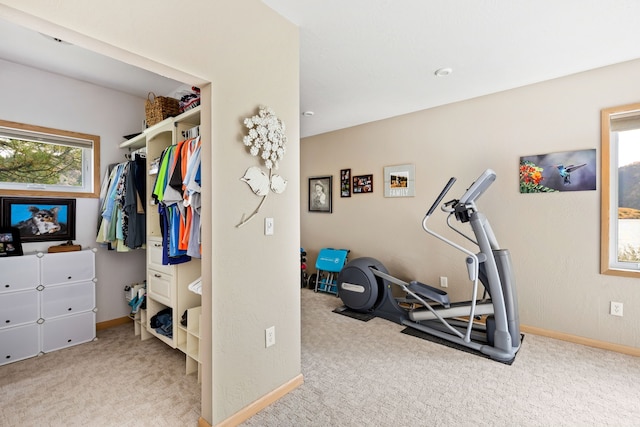 workout area featuring light colored carpet