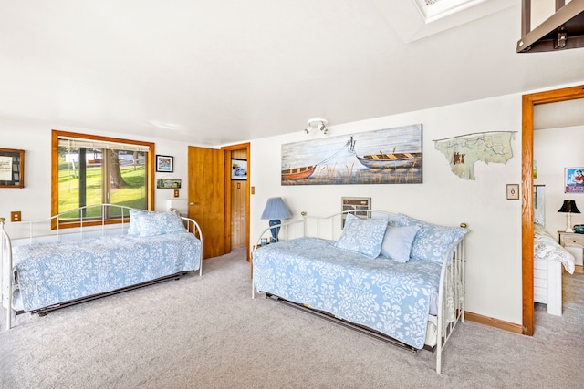 carpeted bedroom featuring a skylight