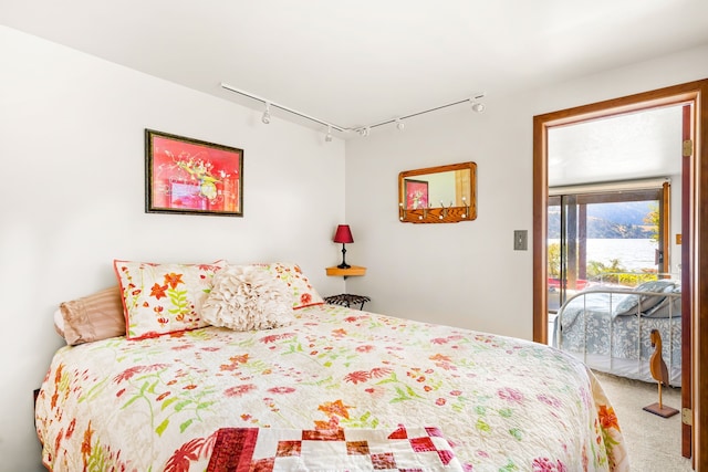 carpeted bedroom with a water view