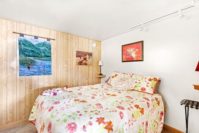 carpeted bedroom with wooden walls