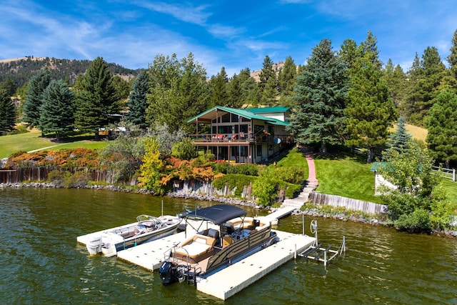 dock area with a yard and a water view