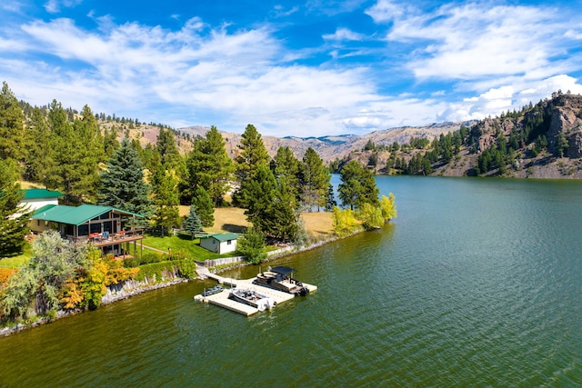 birds eye view of property featuring a water and mountain view