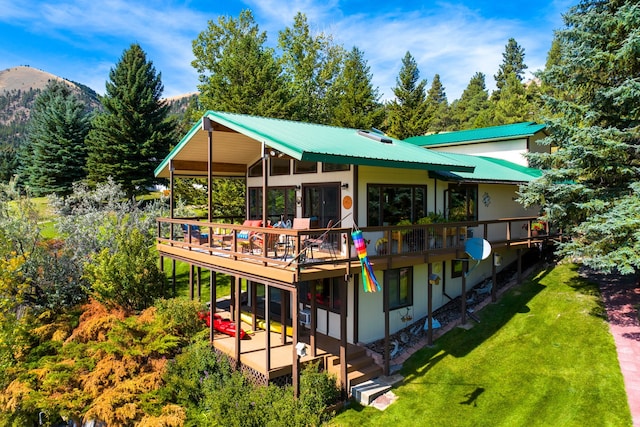 back of house featuring a yard and a deck