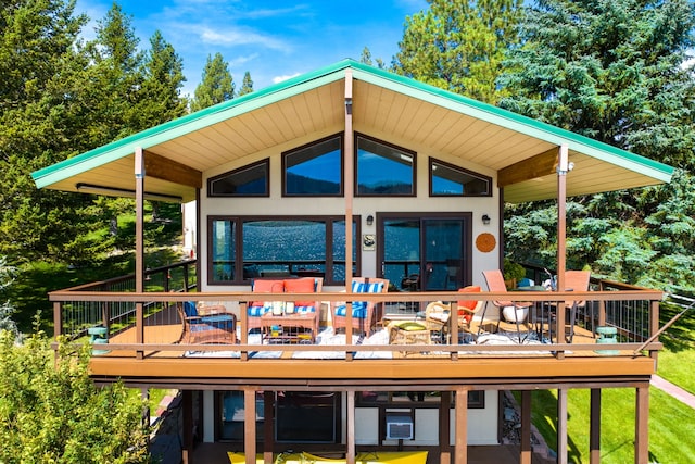 rear view of house featuring a wooden deck