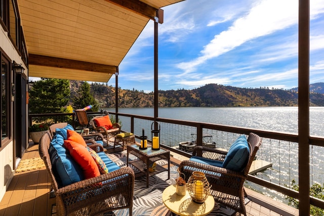 exterior space with a water view, an outdoor hangout area, and a balcony