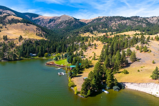 drone / aerial view featuring a water and mountain view